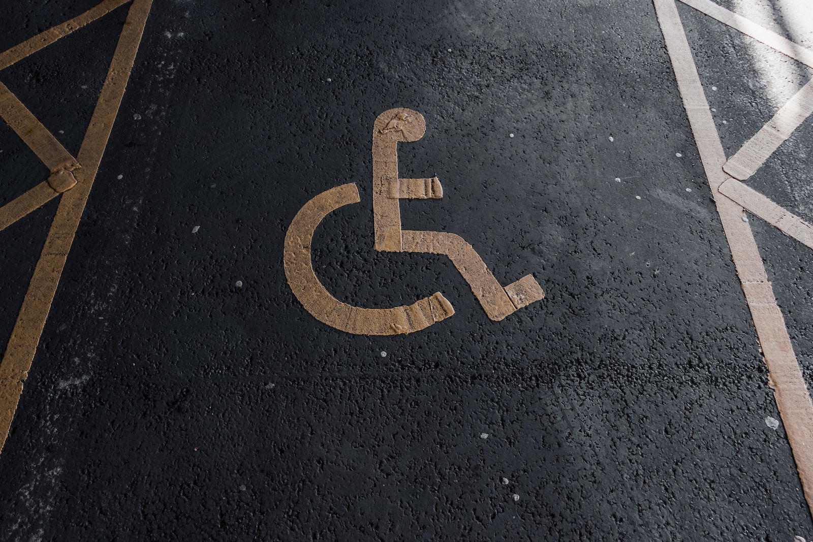 a handicapped sign on the ground in a parking lot