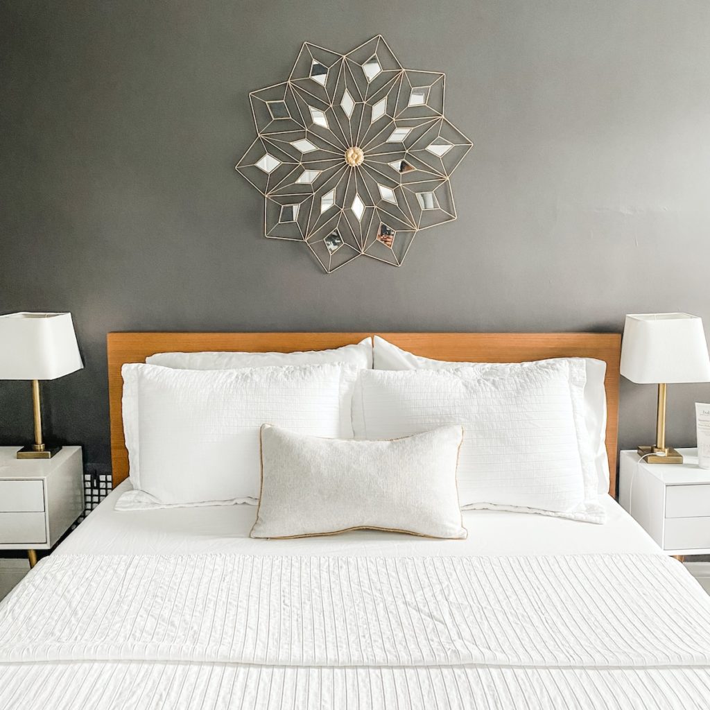 a bed with a white bedspread and pillows